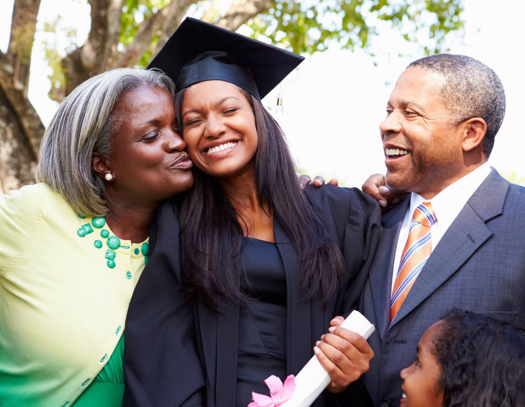 High school graduate celebrates with her parents